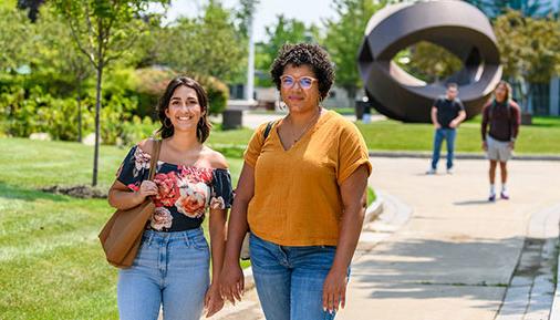 Two women in summer on campus